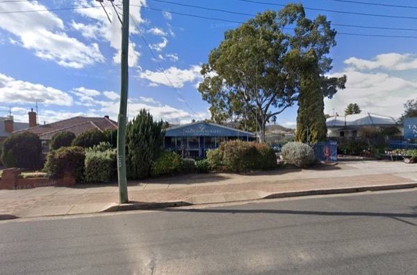 The nursery seen from across Phillip Street, behind a clipped hedge